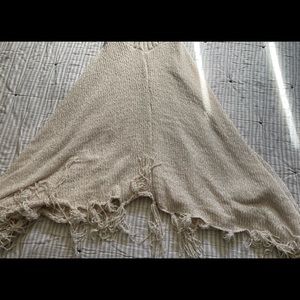 Pinklicious knitted poncho. Used in a crème color